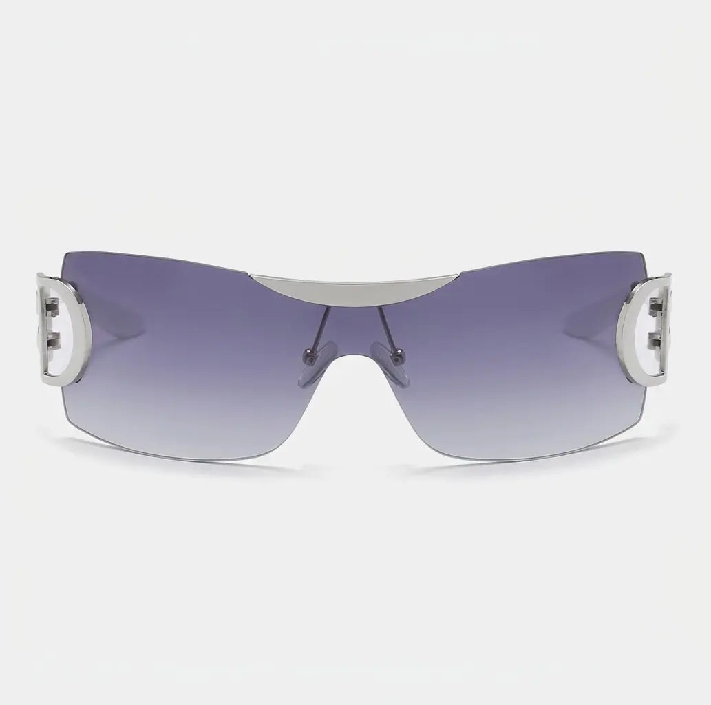 Rimless shield-style sunglasses with purple gradient lenses and silver side accents displayed on a light gray background.