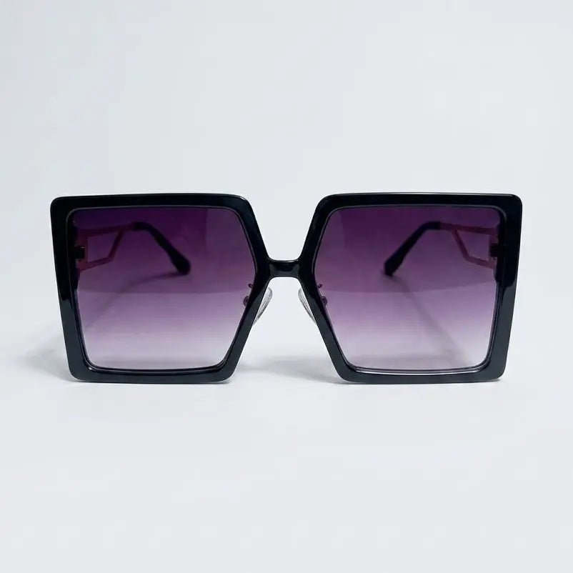 Black sunglasses with gradient purple lenses on a light gray background