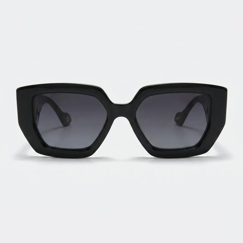 Black sunglasses with dark lenses on a light gray background