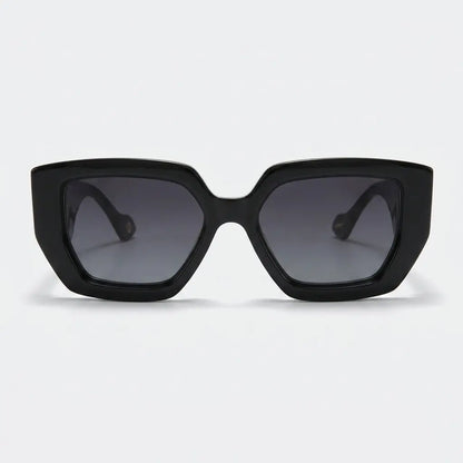 Black sunglasses with dark lenses on a light gray background