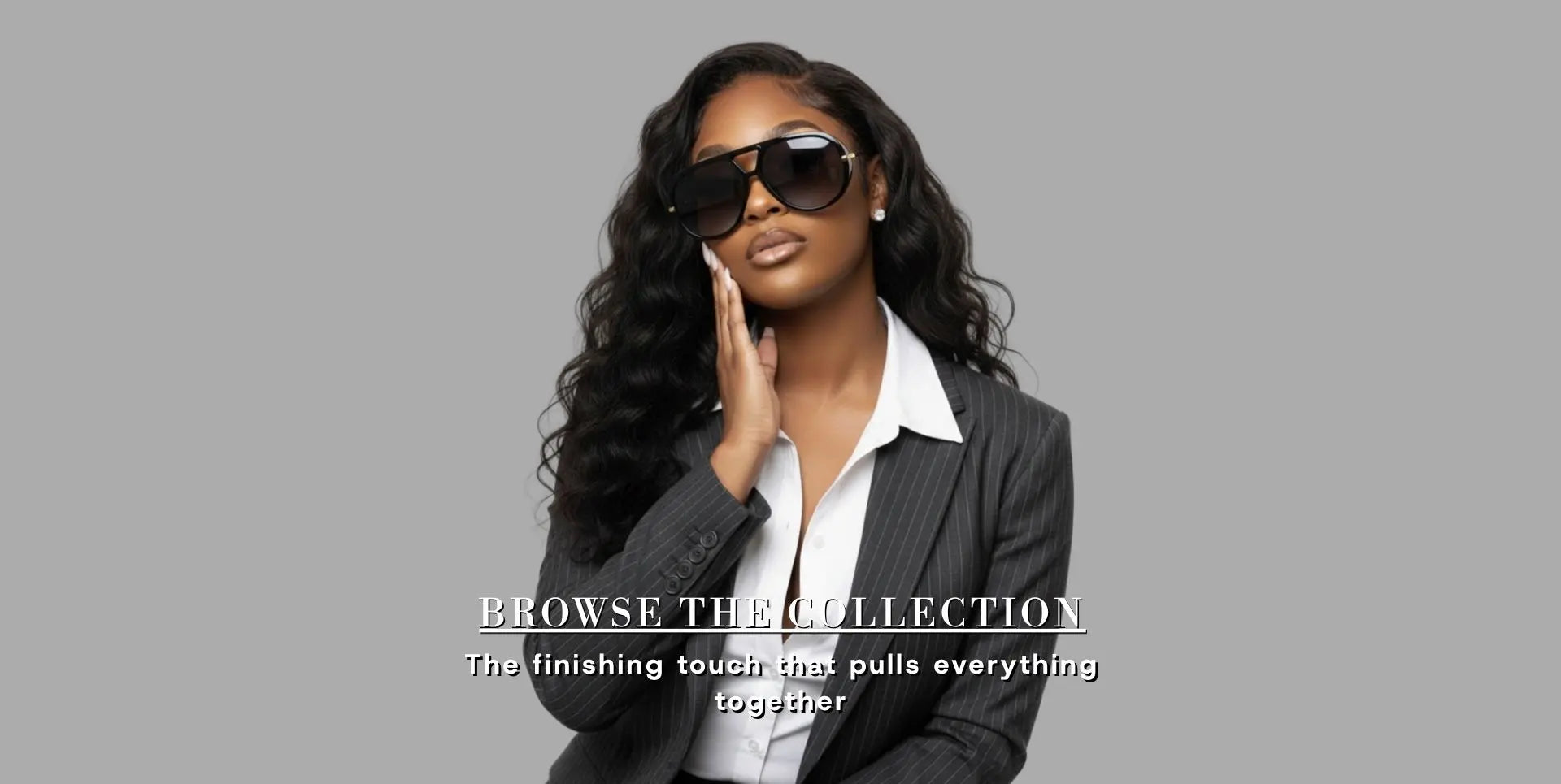Woman wearing sunglasses and a gray blazer with text overlay on a gray background