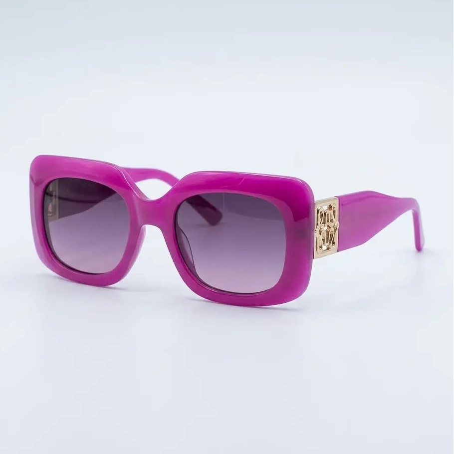 Bright pink square sunglasses with gradient purple lenses and a gold-tone metal logo plate on the temple arm, set against a clean white background.
