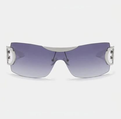 Rimless shield-style sunglasses with purple gradient lenses and silver side accents displayed on a light gray background.