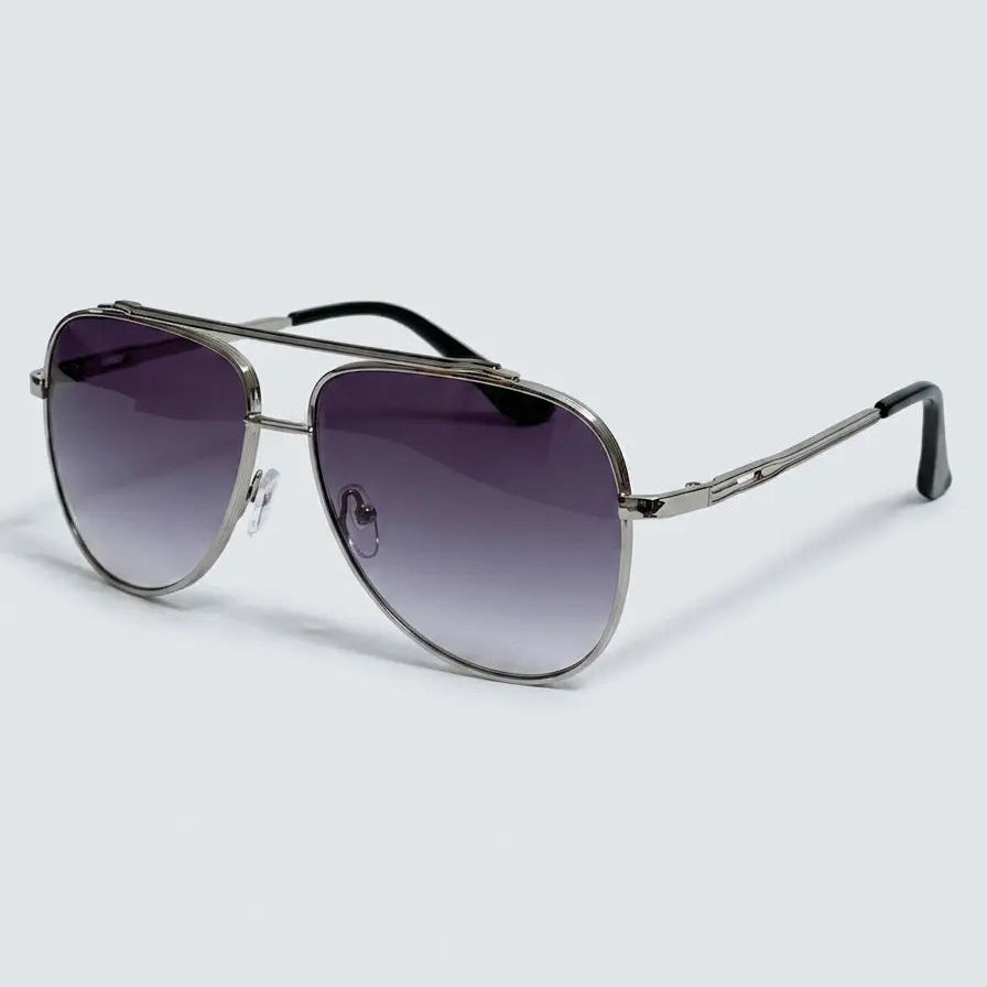 Side profile view of aviator-style sunglasses with a silver metal frame, dark gray lenses and black temple tips displayed on a light gray background.
