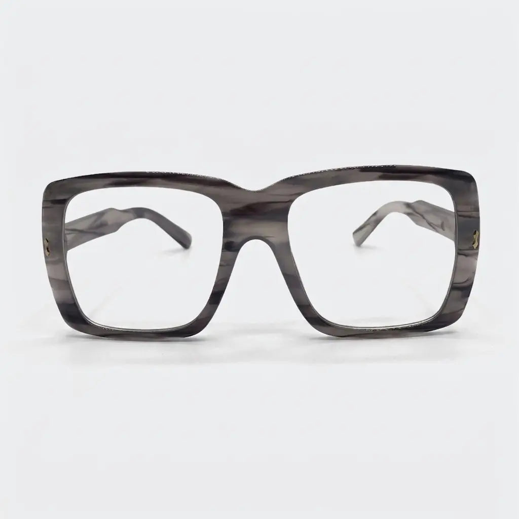 A pair of oversized plastic frame sunglasses with clear lenses and a patterned design.