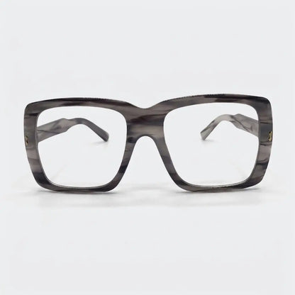 A pair of oversized plastic frame sunglasses with clear lenses and a patterned design.
