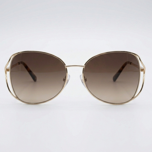 Gold-framed sunglasses with gradient brown lenses on a white background