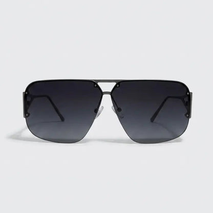 Sunglasses with a gradient black lens on a light gray background