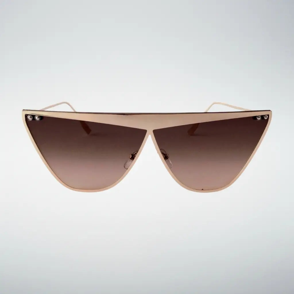 Triangular shield sunglasses with a gold metal frame and brown gradient lenses, shown against a light gray background.