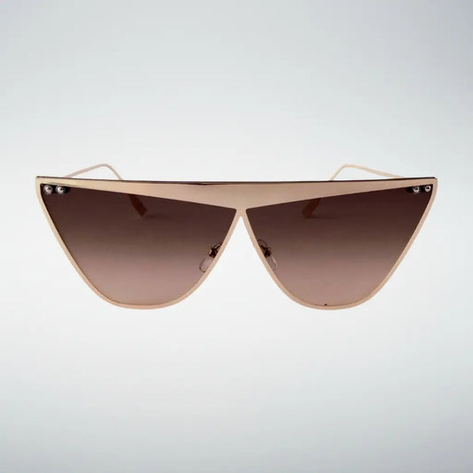 Triangular shield sunglasses with a gold metal frame and brown gradient lenses, shown against a light gray background.