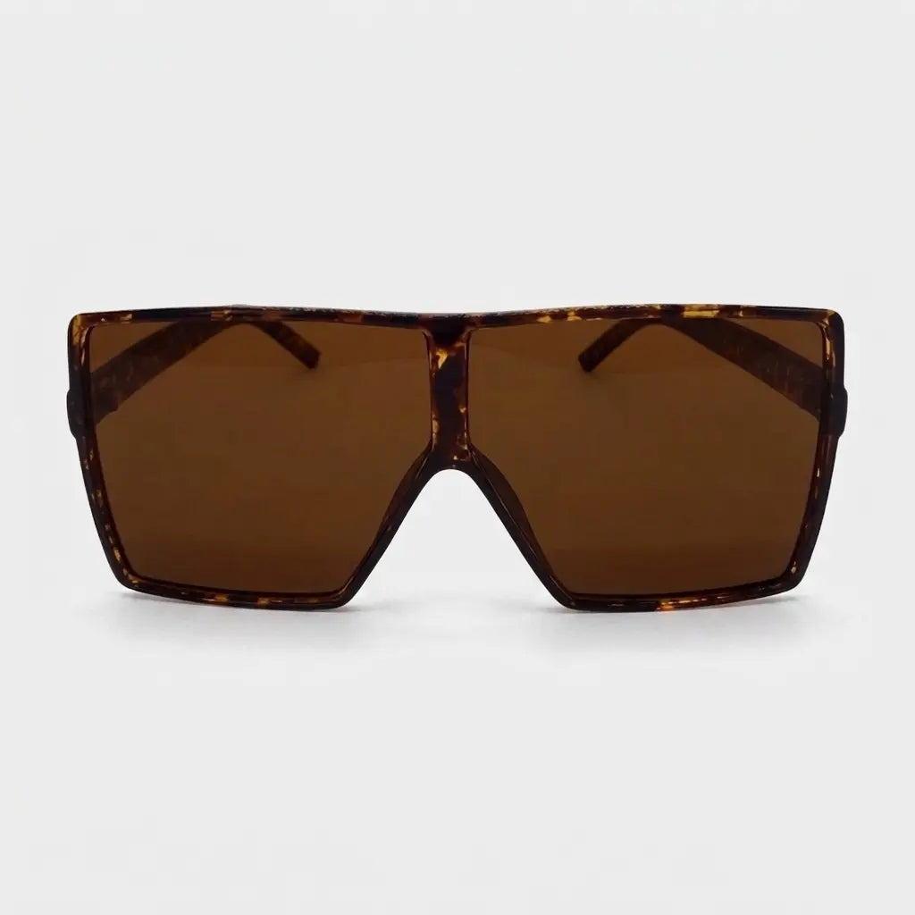 Oversized square sunglasses with a brown tortoise frame and brown lenses displayed on a light gray background.