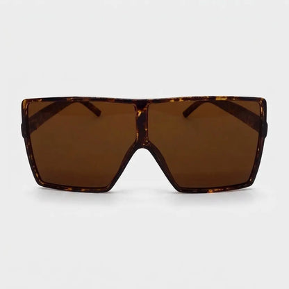 Oversized square sunglasses with a brown tortoise frame and brown lenses displayed on a light gray background.