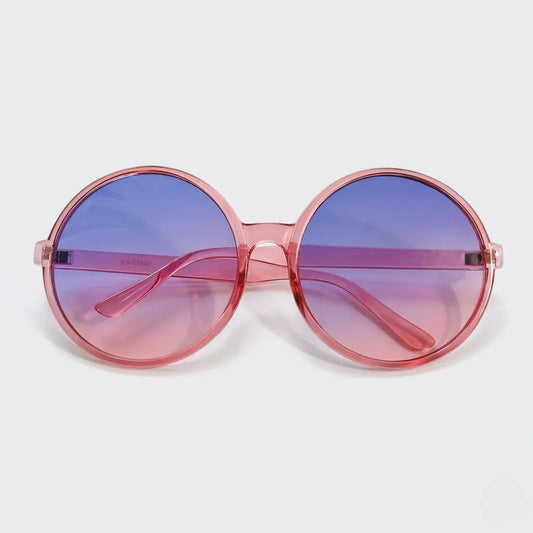 Round sunglasses with a translucent pink frame and purple-to-pink gradient lenses displayed on a light gray background.