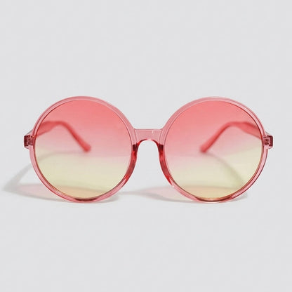 Round sunglasses with a translucent pink frame and pink-to-yellow gradient lenses displayed on a light gray background.