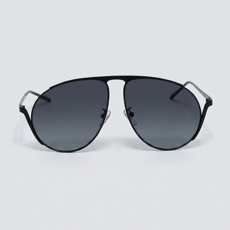 Black sunglasses with gradient lenses on a light gray background