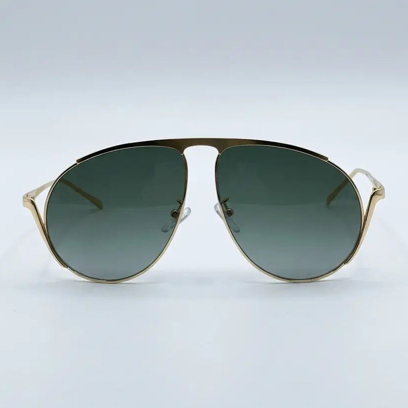 Gold-framed sunglasses with green gradient lenses on a light gray background
