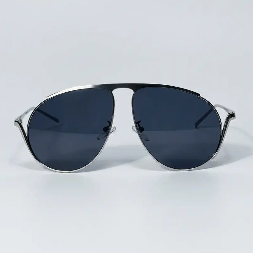Sunglasses with dark lenses and thin metal frame on a light gray background