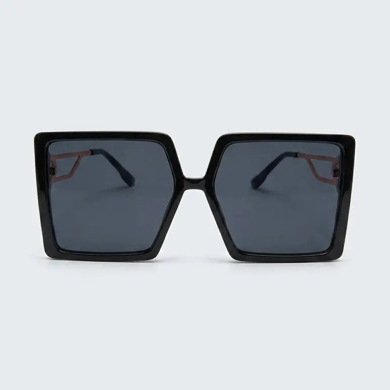 Black sunglasses with dark lenses on a light gray background
