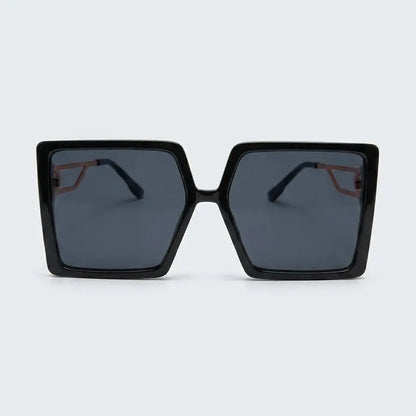 Black sunglasses with dark lenses on a light gray background