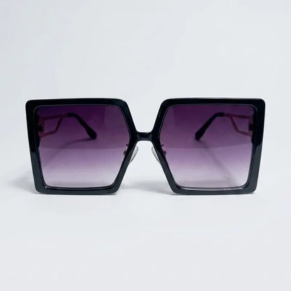 Black sunglasses with gradient purple lenses on a light gray background