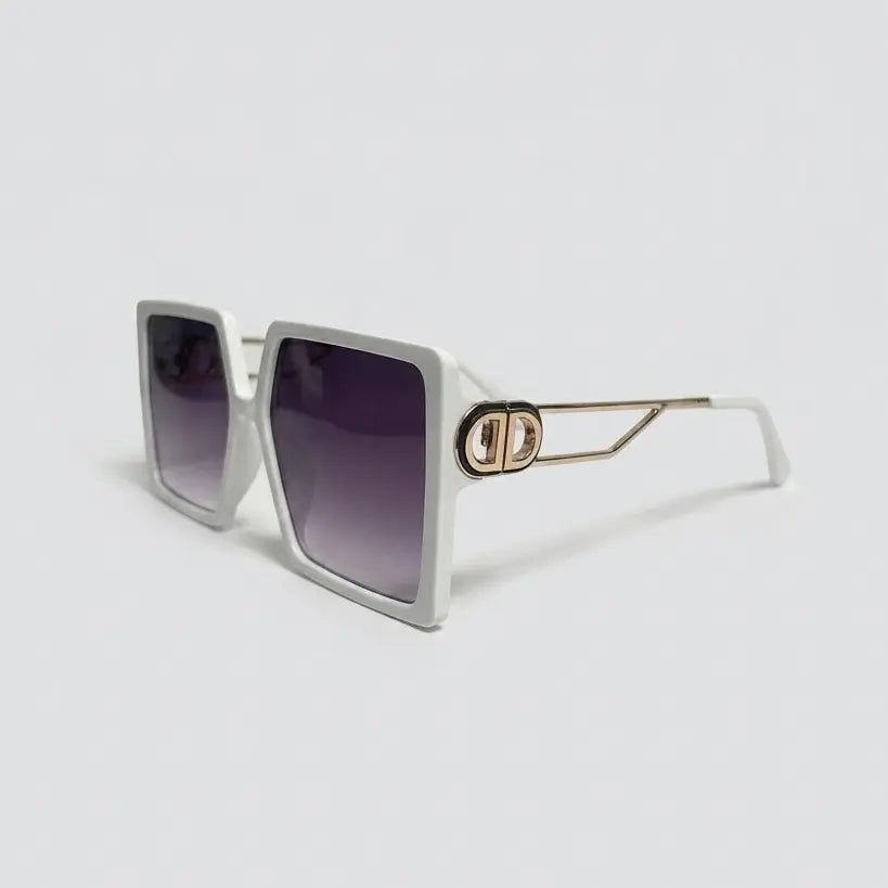 Sunglasses with a gold frame and gradient lenses on a light gray background