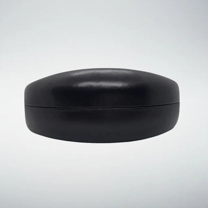 A hardshell black clamshell faux-leather case with a smooth, matte finish, shown against a light gray gradient background.