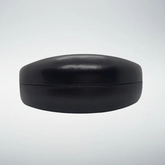 A hardshell black clamshell faux-leather case with a smooth, matte finish, shown against a light gray gradient background.
